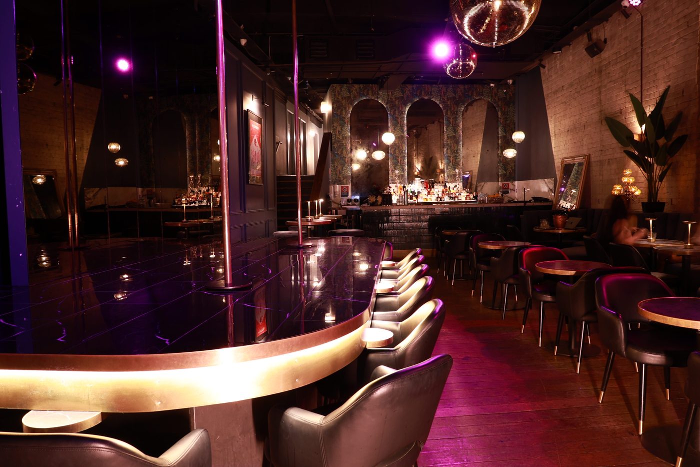 The double pole stage, brass-edged and lit purple